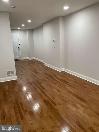 an empty room with wooden floor