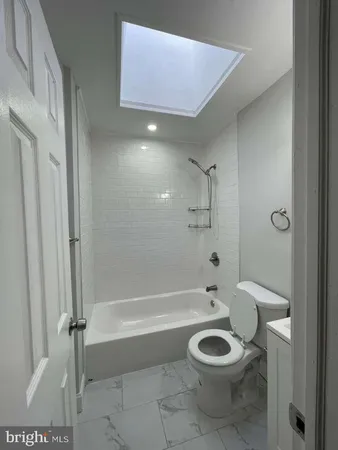 a bathroom with a toilet a sink and shower