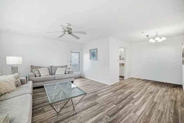 a living room with furniture and a wooden floor