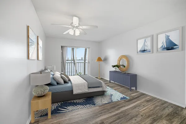 a view of a room with wooden floor and a ceiling fan