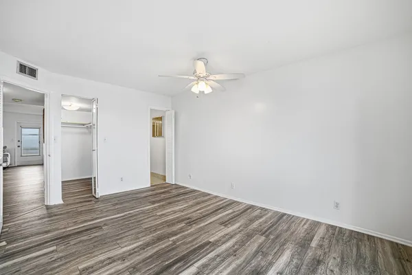 a view of a hallway with wooden floor