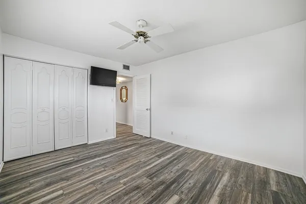 a view of a lake with houses in back