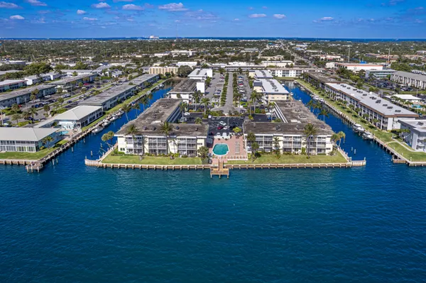 an aerial view of residential houses with outdoor space and trees