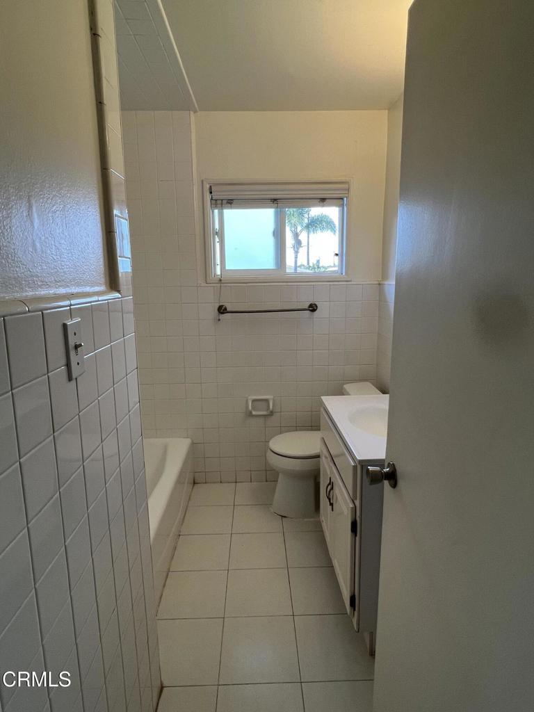 2230 Lassen Street Oxnard, CA 93033 - Photo 9 of 13 a bathroom with a toilet a sink and mirror