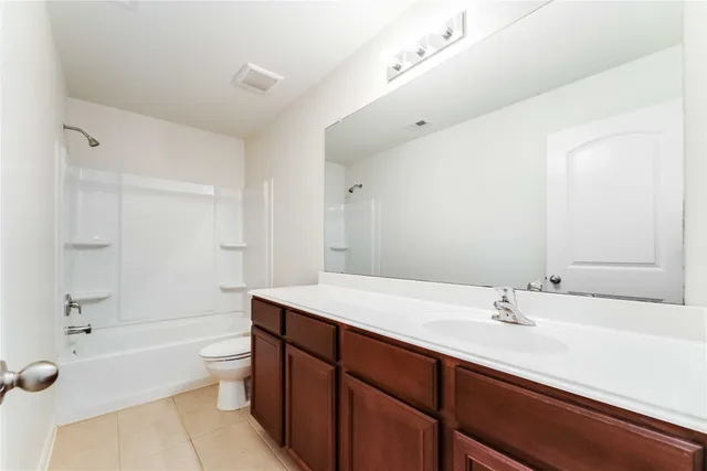 a bathroom with a sink a toilet a shower and a mirror