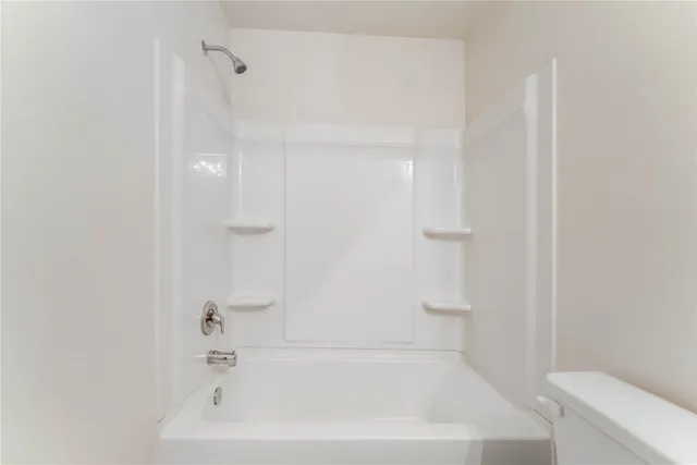 a bathroom with a bathtub and a toilet