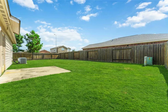 a view of yard with swimming pool and green space