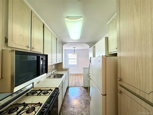a kitchen with stainless steel appliances a refrigerator a stove and cabinets