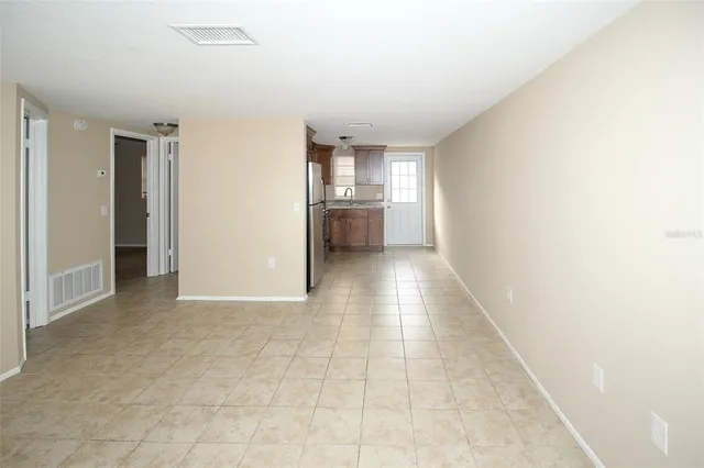 an empty room with a empty space and windows