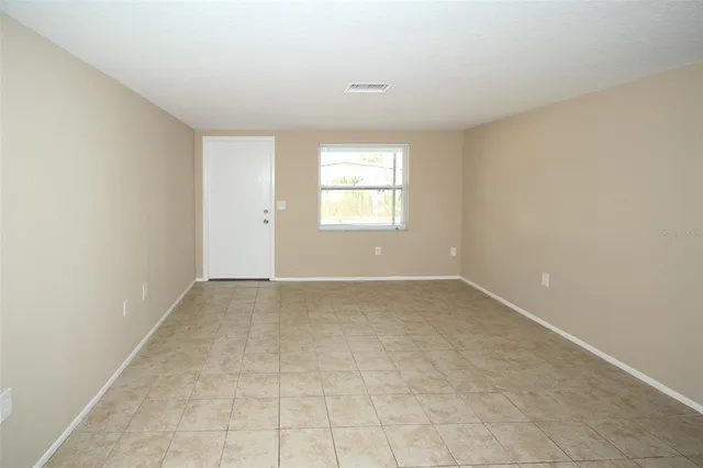 a kitchen with a refrigerator sink and cabinets