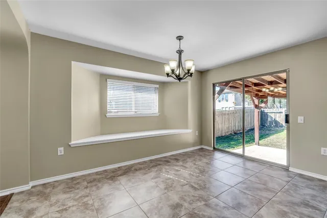 a kitchen with granite countertop a stove and a microwave