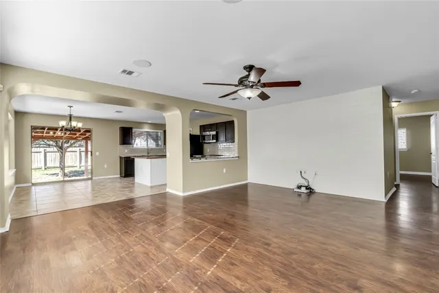 a view of empty room with wooden floor and fireplace