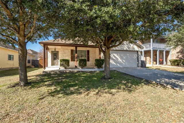 a view of a house with trees in the background
