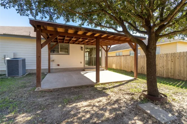 a house that has a tree in front of it