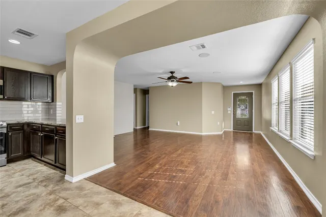 a view of a kitchen with stainless steel appliances kitchen island a sink appliances and cabinets
