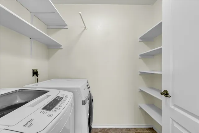 a kitchen with granite countertop a refrigerator and a stove top oven