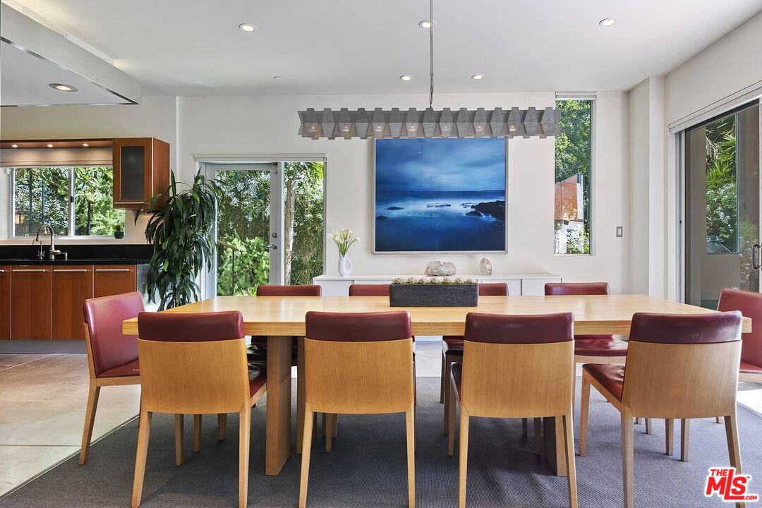 12310 Rochedale Lane Los Angeles, CA 90049 - Photo 16 of 53 a dining room with furniture a chandelier and wooden floor