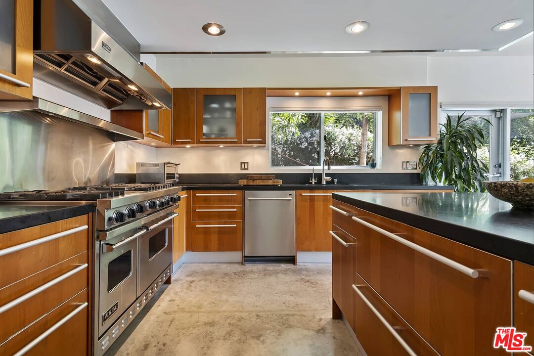 12310 Rochedale Lane Los Angeles, CA 90049 - Photo 20 of 53 a kitchen with stainless steel appliances granite countertop a sink a stove and a refrigerator