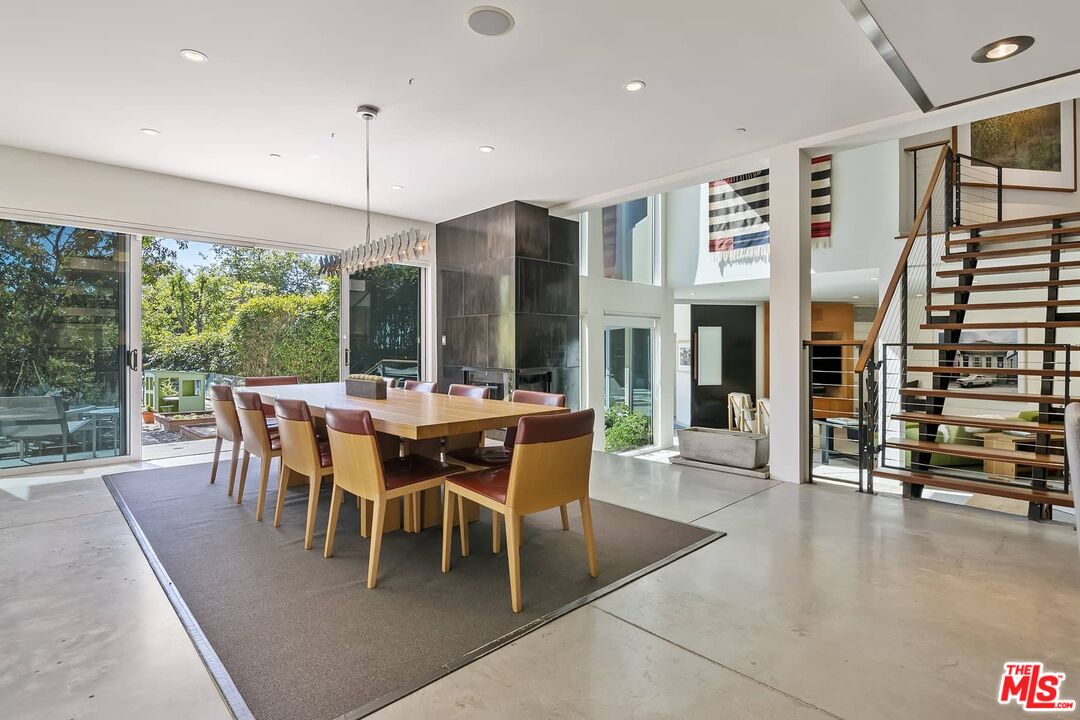 12310 Rochedale Lane Los Angeles, CA 90049 - Photo 22 of 53 a dining room with furniture floor to ceiling window and outdoor view