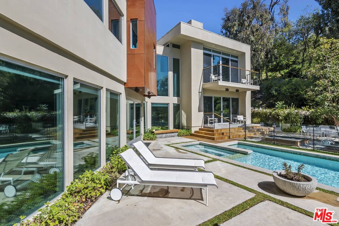 12310 Rochedale Lane Los Angeles, CA 90049 - Photo 26 of 53 a front view of a house with swimming pool having outdoor seating