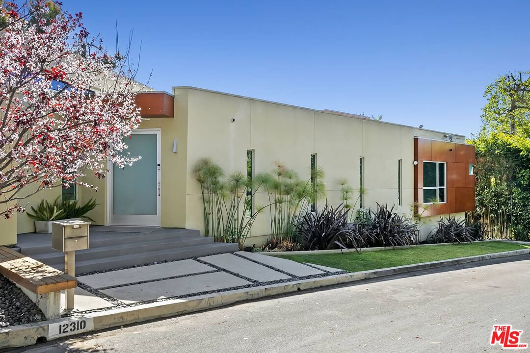 12310 Rochedale Lane Los Angeles, CA 90049 - Photo 3 of 53 a front view of a house with garden