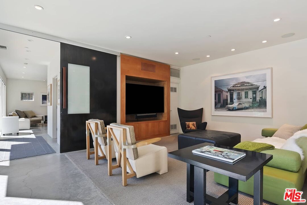 12310 Rochedale Lane Los Angeles, CA 90049 - Photo 31 of 53 a living room with furniture and a flat screen tv
