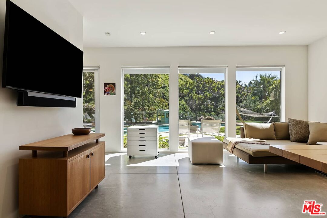12310 Rochedale Lane Los Angeles, CA 90049 - Photo 33 of 53 a living room with furniture and a flat screen tv