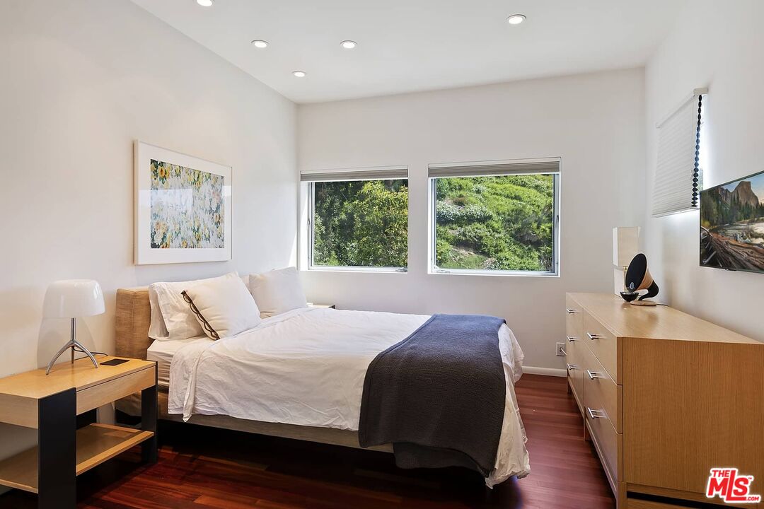 12310 Rochedale Lane Los Angeles, CA 90049 - Photo 36 of 53 a bedroom with a bed and a flat screen tv