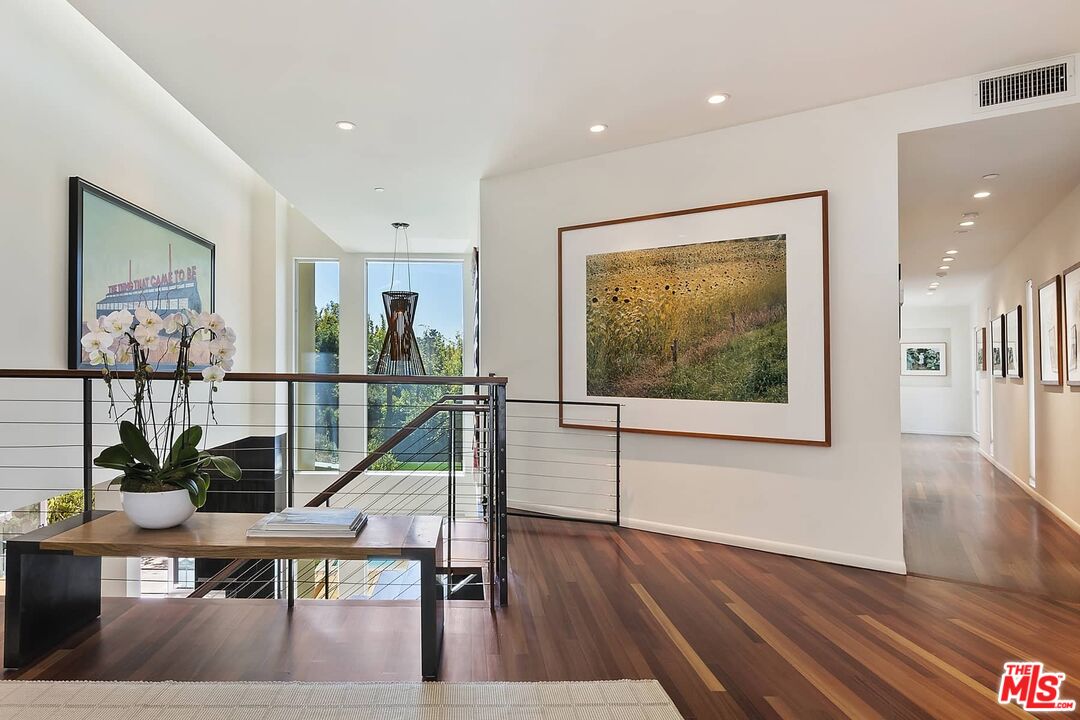 12310 Rochedale Lane Los Angeles, CA 90049 - Photo 4 of 53 a view of a room with wooden floor and windows