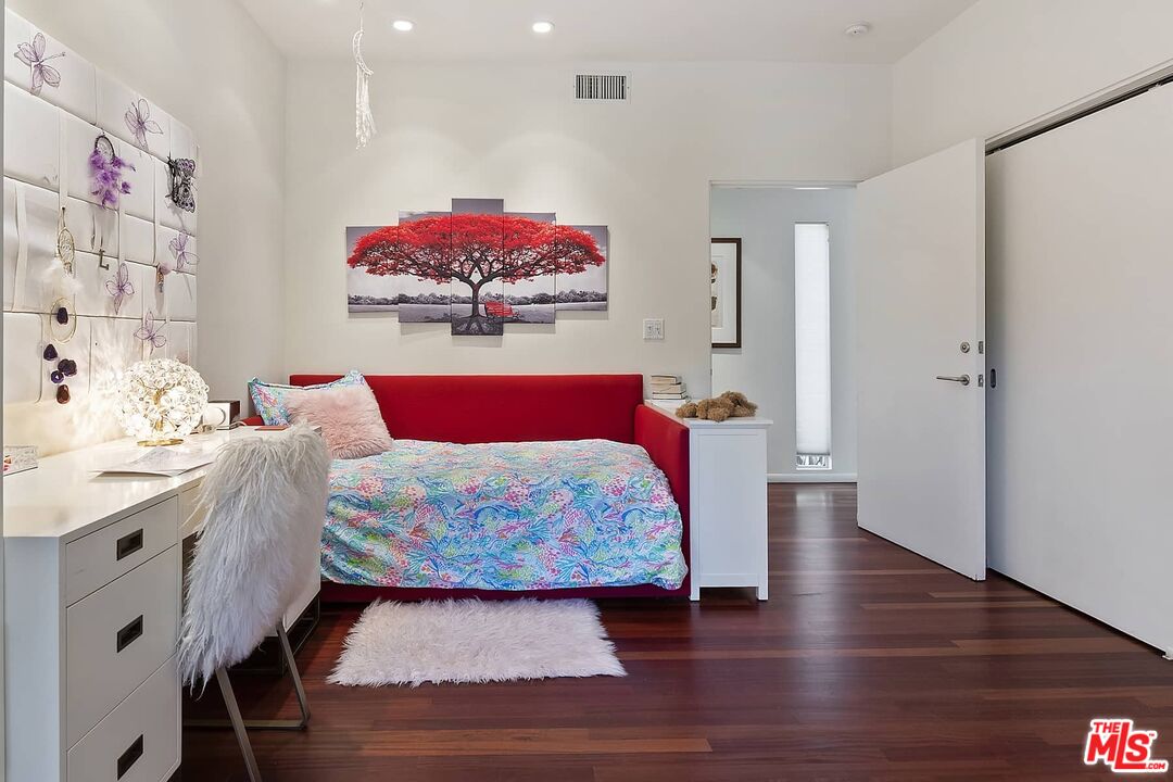 12310 Rochedale Lane Los Angeles, CA 90049 - Photo 41 of 53 a bedroom with a bed and wooden floor