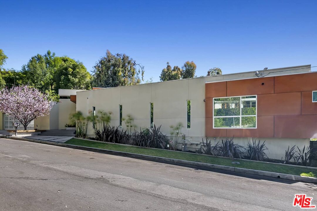12310 Rochedale Lane Los Angeles, CA 90049 - Photo 42 of 53 a front view of a house with a yard and garage