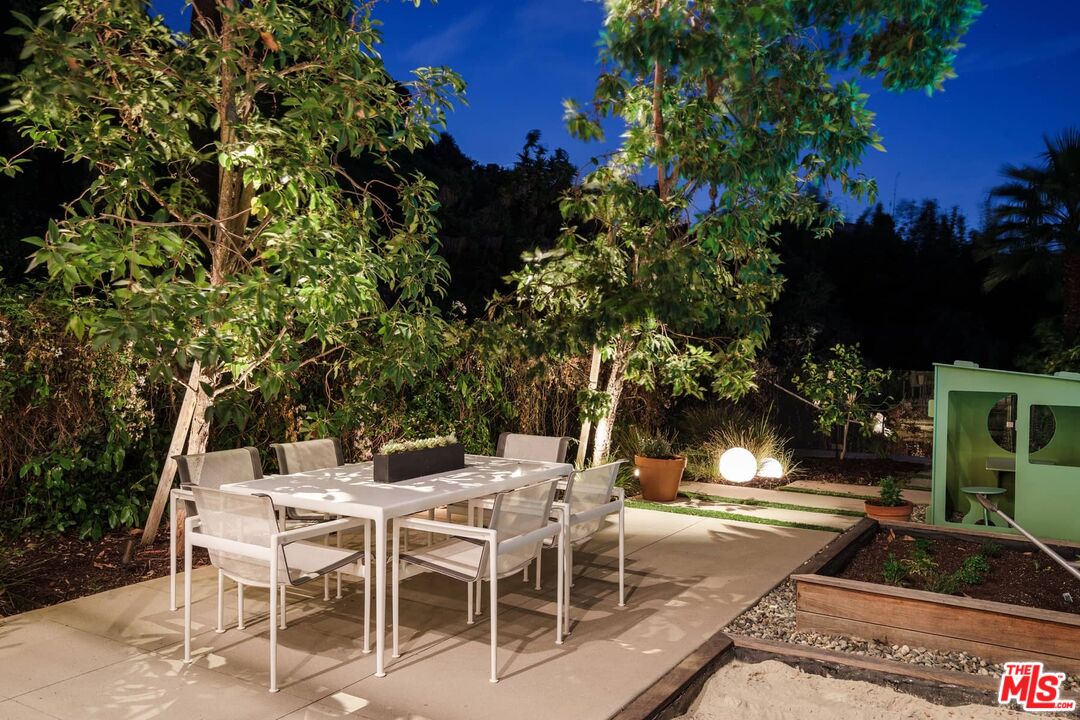 12310 Rochedale Lane Los Angeles, CA 90049 - Photo 50 of 53 a view of a patio with table and chairs and potted plants