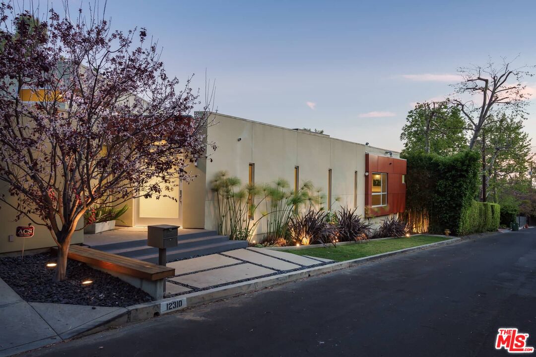 12310 Rochedale Lane Los Angeles, CA 90049 - Photo 51 of 53 a front view of a house with a yard and tree s