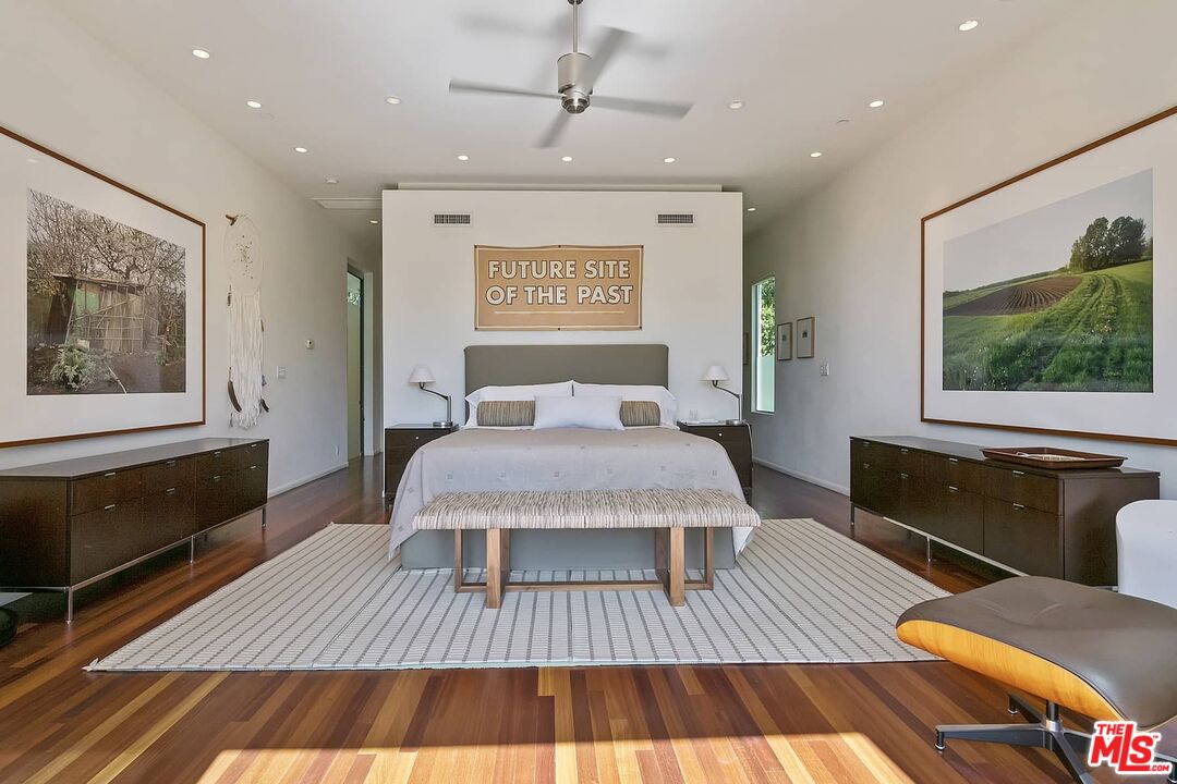12310 Rochedale Lane Los Angeles, CA 90049 - Photo 7 of 53 a spacious bedroom with a bed a dresser and wooden floor