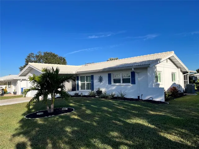 an aerial view of a residential houses with outdoor space and ocean view
