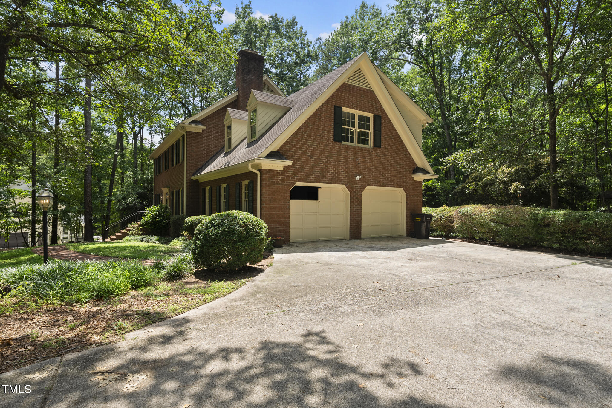 821 Ascot Lane Raleigh, NC 27615 - Photo 42 of 43 a front view of a house with a yard and garage