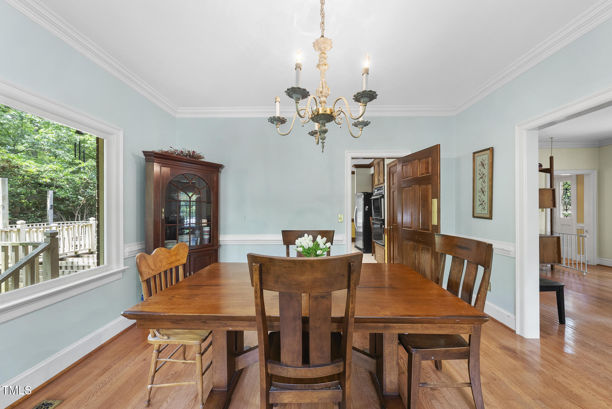 821 Ascot Lane Raleigh, NC 27615 - Photo 8 of 43 a view of a dining room with furniture a chandelier and wooden floor