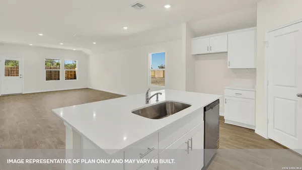 a kitchen with a sink and a refrigerator