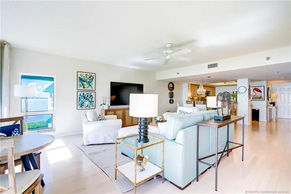 a hallway with a potted plant on a counter and a sink