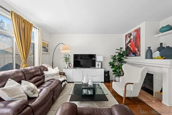 a living room with furniture fireplace and flat screen tv