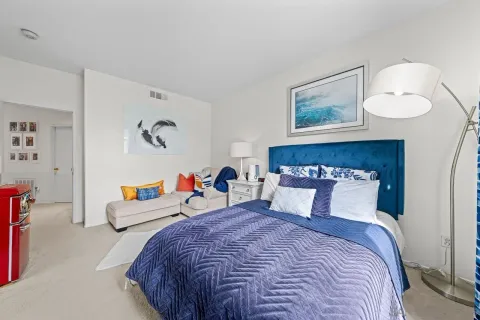 a bedroom with bed and wall painting