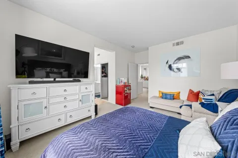 a bedroom with furniture and flat screen tv