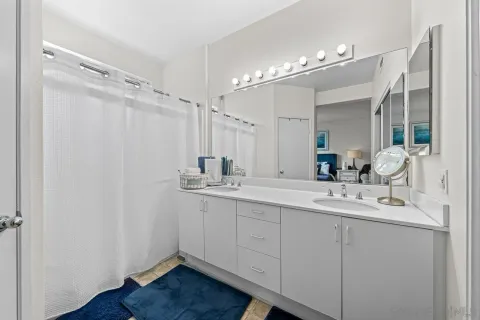 a bathroom with a double vanity sink mirror and double
