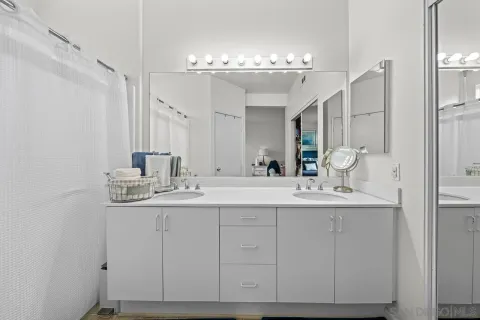 a bathroom with a double vanity sink and a mirror