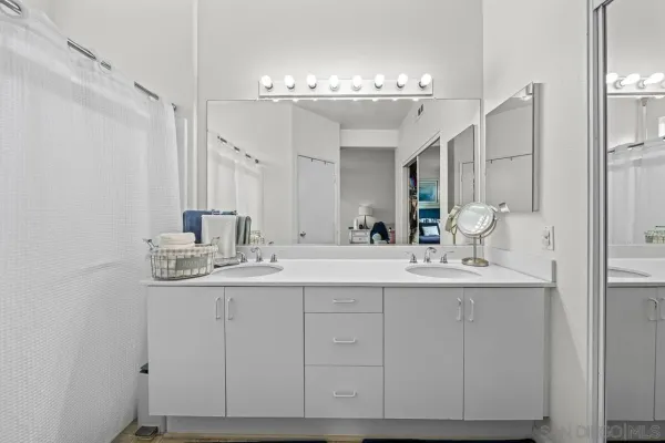a bathroom with a double vanity sink and a mirror