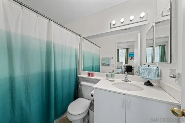 a bathroom with a sink a toilet and mirror