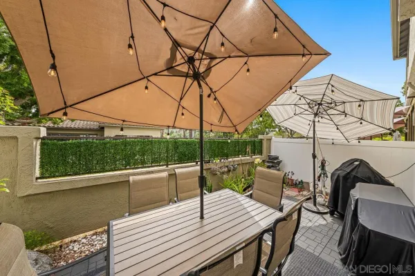 a view of deck with table and chairs with wooden floor and fence