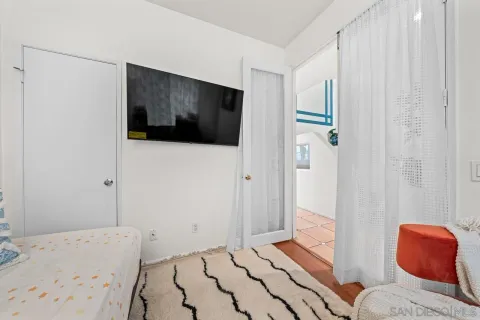 a bedroom with a bed and a view of bathroom