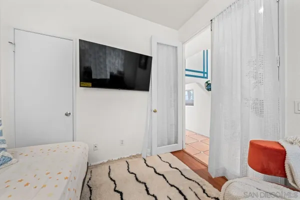 a bedroom with a bed and a view of bathroom