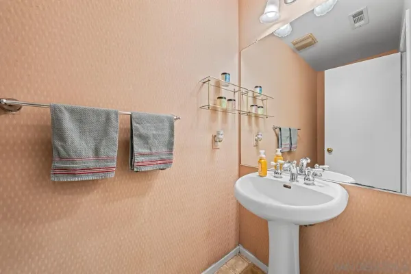 a bathroom with a sink mirror and vanity